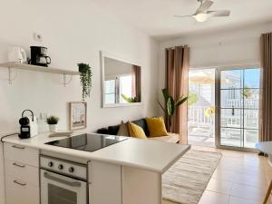a kitchen and living room with a couch and a table at Luxury Apartment Tenerife in Adeje