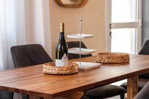 a bottle of wine sitting on top of a wooden table at Mermaid Villa 16 in Ayia Napa