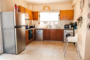a kitchen with a stainless steel refrigerator and a dishwasher at Mermaid Villa 16 in Ayia Napa