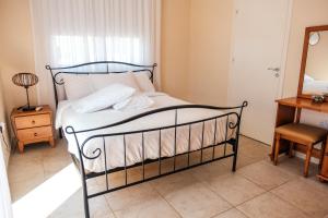 a bedroom with a bed and a table and a mirror at Mermaid Villa 16 in Ayia Napa +28 photos