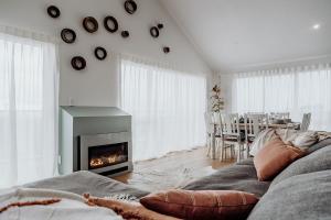a living room with a couch and a fireplace at Sailor's Catch in Hokitika