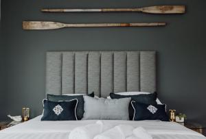 a bedroom with a bed with blue and white pillows at Sailor's Catch in Hokitika