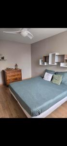 a bedroom with a large bed and a dresser at Maison Villa in Chenôve