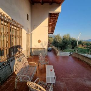 a patio with chairs and a table on a building at Villa Panno, posto romantico! in Serre
