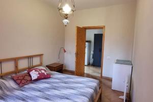 a bedroom with a bed and a chandelier at Villa Panno, posto romantico! in Serre +43 photos