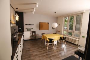 a kitchen and dining room with a yellow table and chairs at Large 120m apartment with garden and cat near ZOO in Prague +17 photos