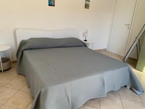 En eller flere senge i et værelse på Casa vacanza Mamaioa