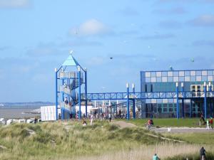 a building on a beach with a playground at Pension Lilli in Norddeich