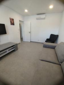 a living room with a couch and a tv at Casa lisboa in Livramento +3 photos