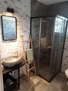 a bathroom with a sink and a shower at Vikendica Maša Blu in Šljivovica +27 photos