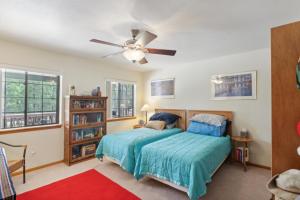 a bedroom with a bed and a ceiling fan at Secluded Mountain Cabin with Forest Views cabin in Happy Jack