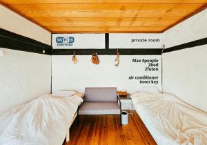 Postel nebo postele na pokoji v ubytování hinatabocco guesthouse