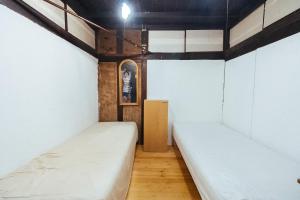 Postel nebo postele na pokoji v ubytování hinatabocco guesthouse