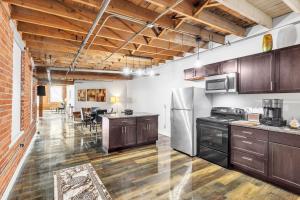 an open kitchen with wooden cabinets and appliances at Stylish Chic Retreat at Lafayette Lofts apts in Detroit