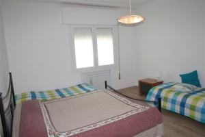 una camera con due letti e una finestra di Nereadi Family Apartment a Lido di Jesolo