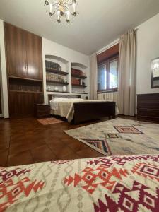 a bedroom with a bed and a chandelier at Casa tra le vigne in Mombercelli
