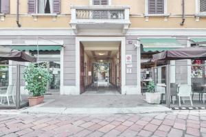 a store front with chairs and tables in a building at Easylife - Milano - Muratori 10 - Porta Romana in Milan