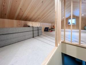 a room with a bed and wooden ceiling at Stunning 3 Bedroom Family Friendly Retreat in Tvøroyri