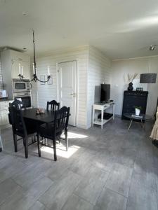 a kitchen and dining room with a table and chairs at Utterbyn/Sirsjön in Persby