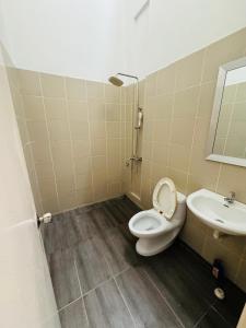 a bathroom with a toilet and a sink at HmHome-Four in Rumah Ide +9 photos