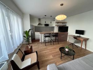 a living room with a couch and a table with chairs at Bel appartement Ouest Parisien in Boulogne-Billancourt