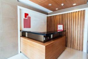 a lobby of a building with a wall at Urban Deca Tower OYO in Manila