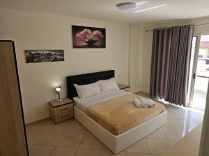 En eller flere senge i et værelse på Apartament Seaview