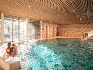 a group of people sitting in a swimming pool at The Brookside Escape in Antoing +31 photos