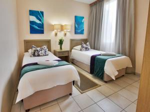 Postel nebo postele na pokoji v ubytování First Group Desert Rose