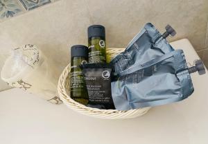 a basket with two bottles of wine and a bag at Albergo Bouganville in Favignana