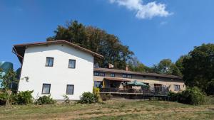 a large white house on a hill with trees at U Kodrů in Semily