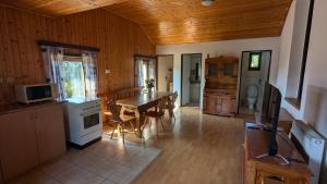a kitchen and dining room with a wooden ceiling at U Kodrů in Semily