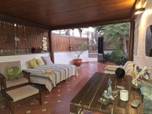 a patio with a couch and a table at Oasis Los Porches in Playa del Ingles