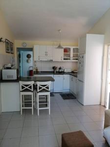 a kitchen with white appliances and a table and chairs at Oasis Los Porches in Playa del Ingles +11 photos