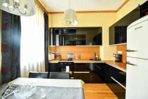 a kitchen with a table and a dining room at Luxury Apartment in Braşov