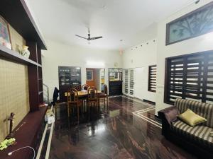 a living room with a table and chairs at Shibus in Thodupuzha