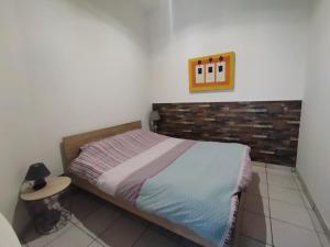 a bedroom with a bed and a table and a picture at Chalet Elaïa in Eaux-Bonnes