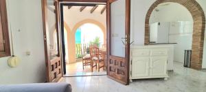 a kitchen with an open door leading to a balcony at Chalé Almaria in Oliva