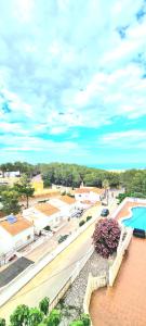 a view of a town with a pool and buildings at Chalé Almaria in Oliva