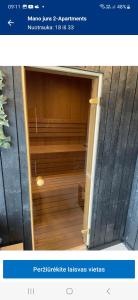 an open door to a room with wooden floors at Apartamentai in Palanga +26 photos