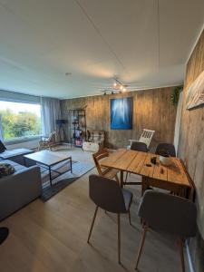 a living room with a wooden table and chairs at Lyngen accommodation and sauna in Lyngseidet