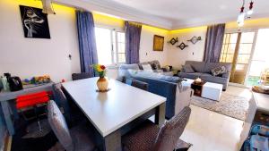 a living room with a table and chairs at 2 Bedroom apartment on luxury delta Sharm resort in Sharm El Sheikh