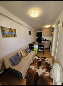 a living room with a couch and a table at Your Davao Home, Awaits You at Arezzo Place Davao! in Sasabayou