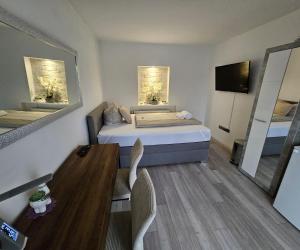 a small room with a bed and a dining table at Perfekt suite Sunny room 2 in Dinkelsbühl