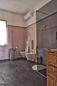 a bathroom with a sink and a toilet and a window at Tra gli ulivi da Giacinta in Varazze +11 photos