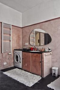 a kitchen with a washing machine and a mirror at Tra gli ulivi da Giacinta in Varazze +11 photos