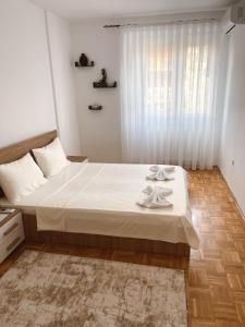 a bedroom with a bed with two towels on it at Apartment Troi in Pristina
