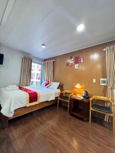 a bedroom with a bed and a table and chairs at Phúc Đạt Container in Vung Tau