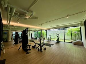 a gym with treadmills and exercise bikes in a room at 5 mins to Ari - Sutthisan in Bang Su