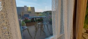 a window view of a balcony with a view of a building at Perfekt suite Sunny room 2 in Dinkelsbühl